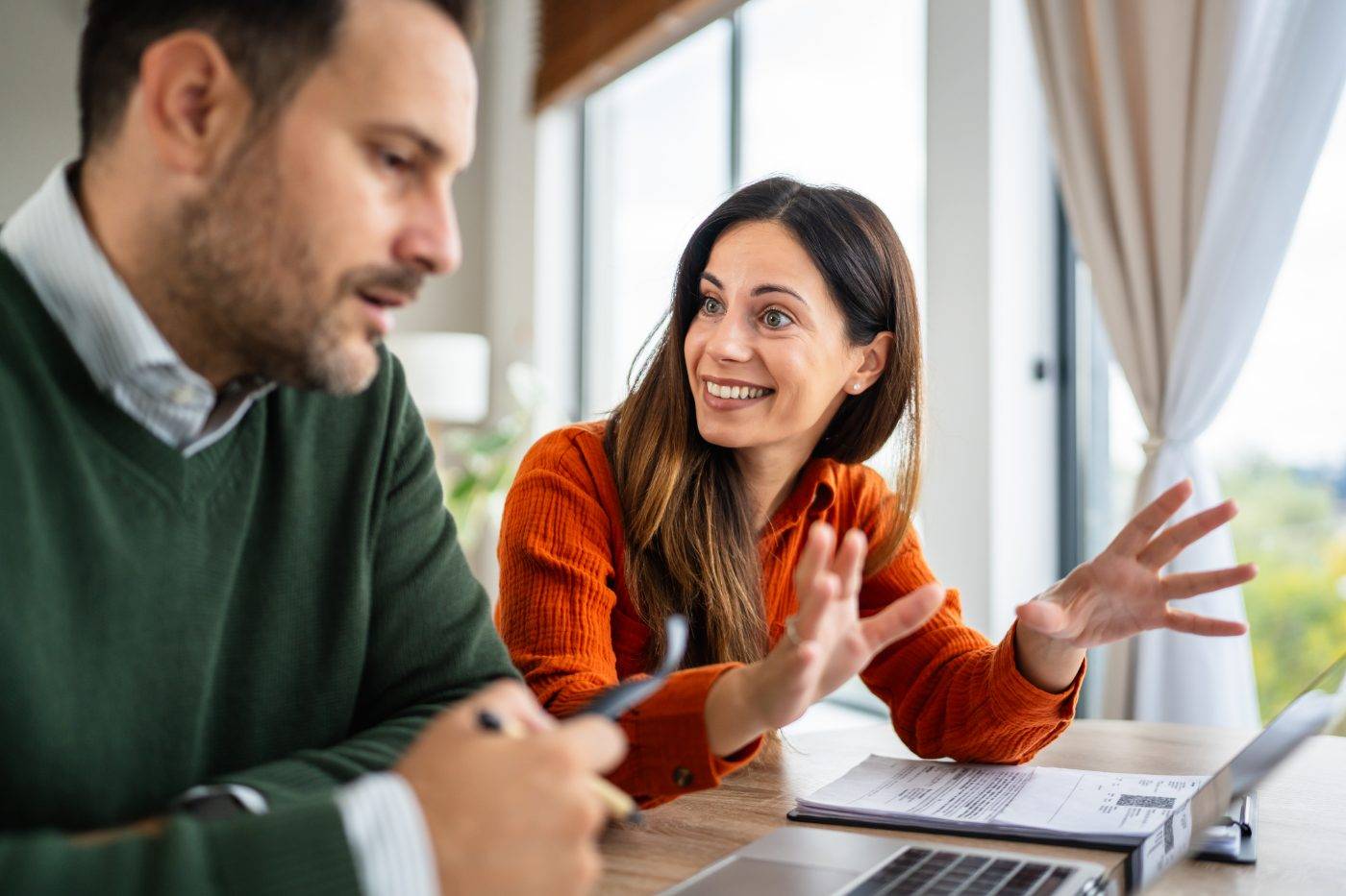 Expert Nearby hero, couple at laptop (iStock 2241456642) A couple talking face to face over a laptop at home